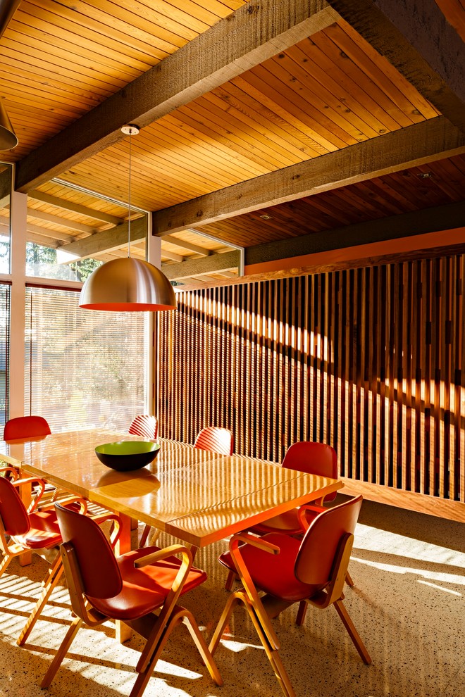 This is an example of a mid-sized midcentury open plan dining in Portland with concrete floors and multi-coloured floor.