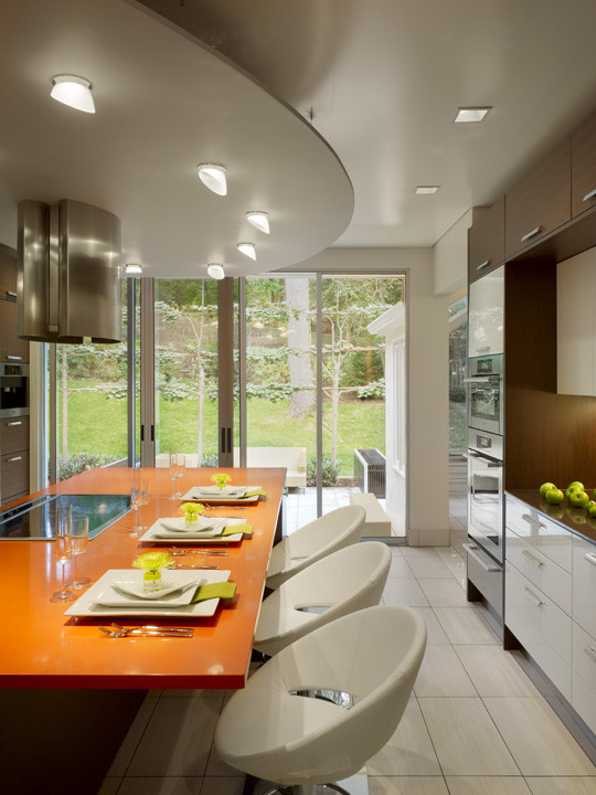 Inspiration for a large contemporary galley eat-in kitchen in Philadelphia with a double-bowl sink, open cabinets, white cabinets, quartz benchtops, beige splashback, glass tile splashback, stainless steel appliances, porcelain floors and with island.