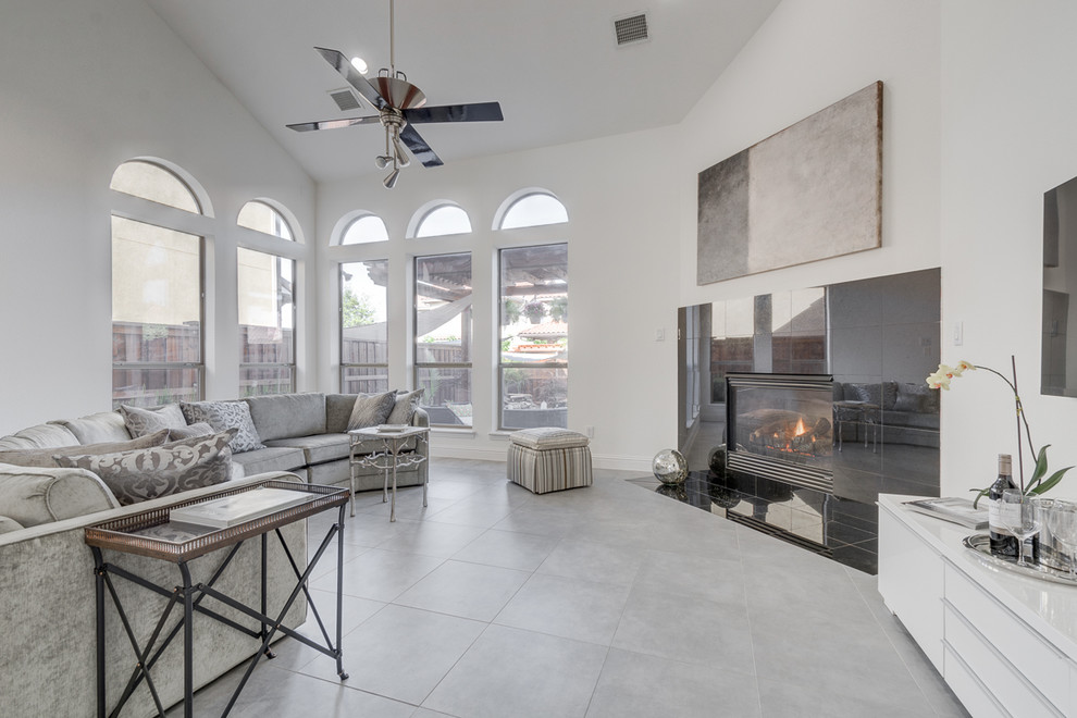 Contemporary formal open concept living room in Dallas with white walls, porcelain floors, a standard fireplace, a tile fireplace surround and a wall-mounted tv.