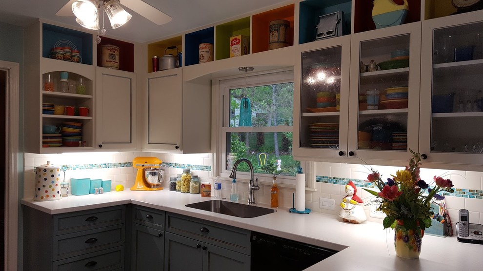 Inspiration for a mid-sized eclectic u-shaped medium tone wood floor and brown floor eat-in kitchen remodel with an undermount sink, recessed-panel cabinets, white cabinets, laminate countertops, white backsplash, subway tile backsplash, stainless steel appliances, no island and white countertops