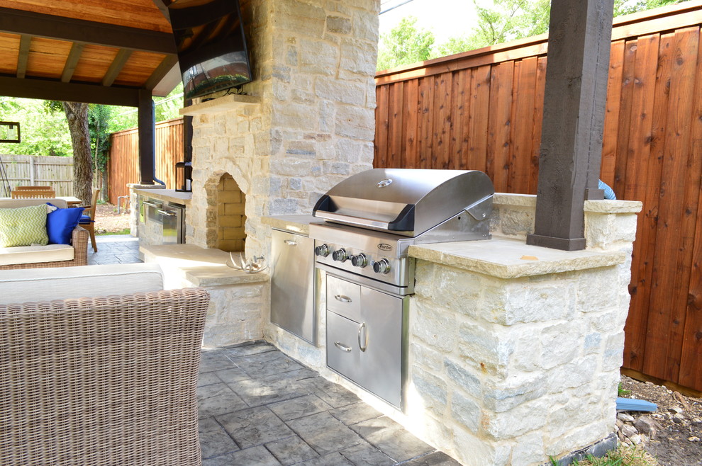 Inspiration for a huge country backyard stone patio kitchen remodel in Dallas