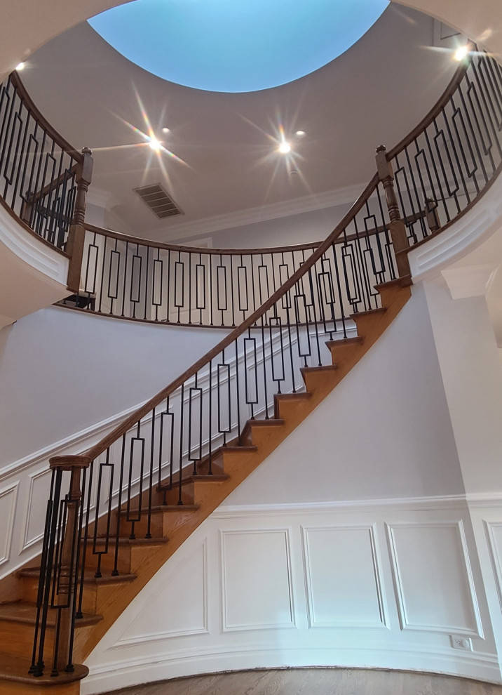 Photo of a mid-sized contemporary wood curved staircase in Philadelphia with wood risers and mixed railing.