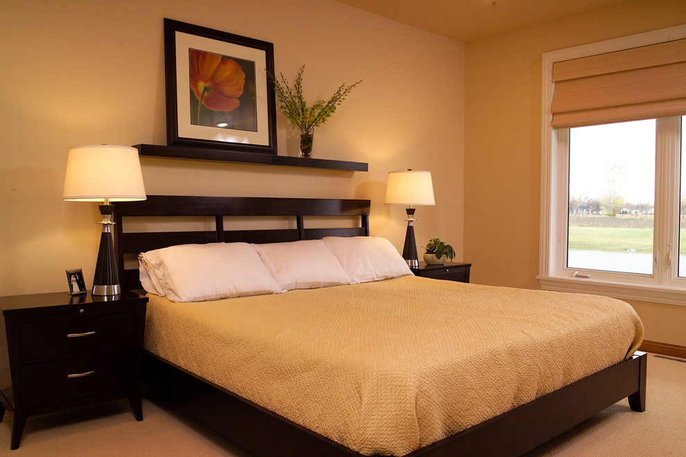 This is an example of a mid-sized transitional master bedroom in Other with beige walls, carpet and no fireplace.