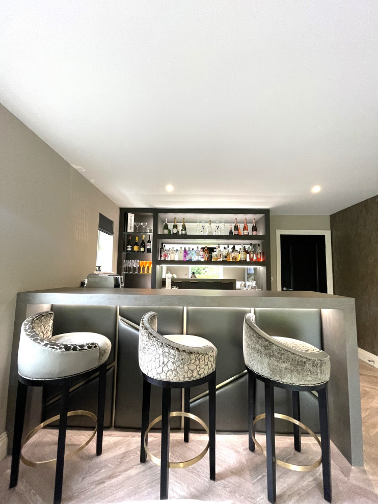 Photo of a medium sized contemporary u-shaped home bar in Other with flat-panel cabinets, vinyl flooring and feature lighting.
