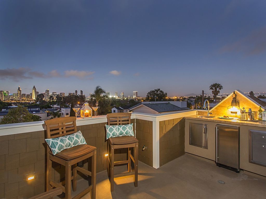 Photo of a mid-sized beach style rooftop deck in San Diego with an outdoor kitchen and no cover.
