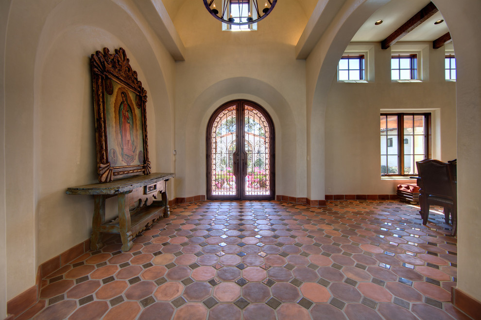 Large mediterranean foyer in Austin with a double front door.