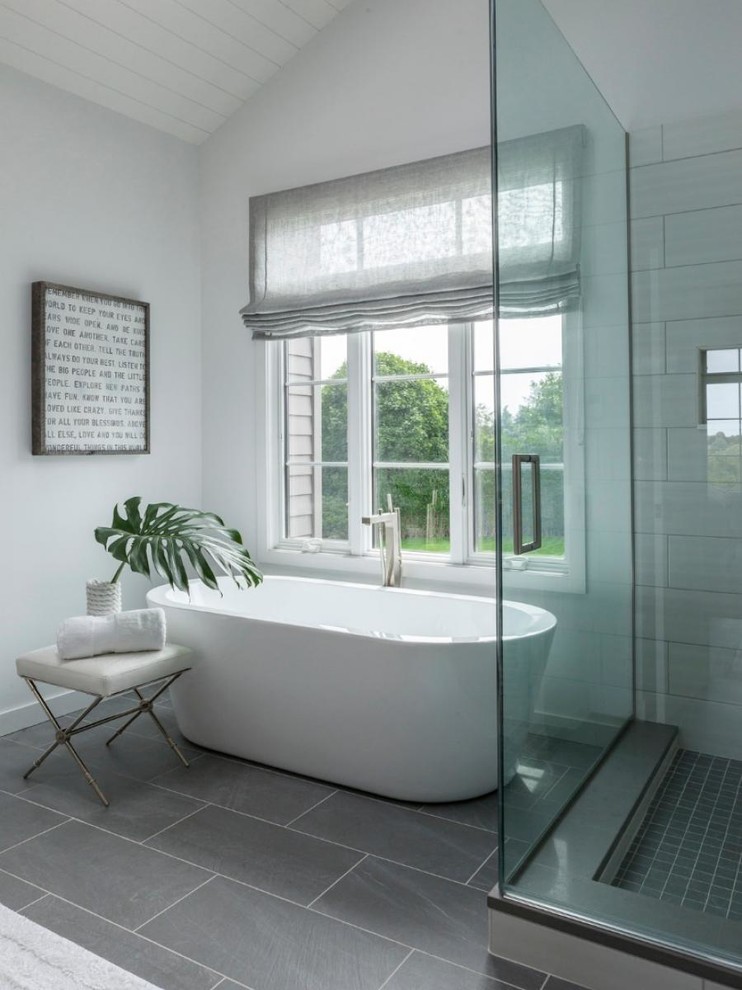 Inspiration for a mid-sized contemporary master bathroom in New York with a freestanding tub, an alcove shower, gray tile and porcelain floors.