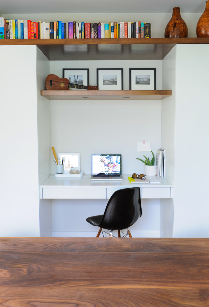 Inspiration for a mid-sized modern study room in Vancouver with white walls and a built-in desk.
