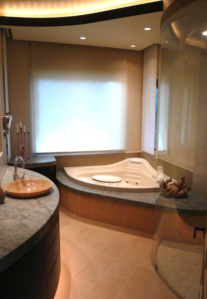 This is an example of a contemporary master bathroom in Sacramento with flat-panel cabinets, dark wood cabinets, granite benchtops, a corner tub and an open shower.