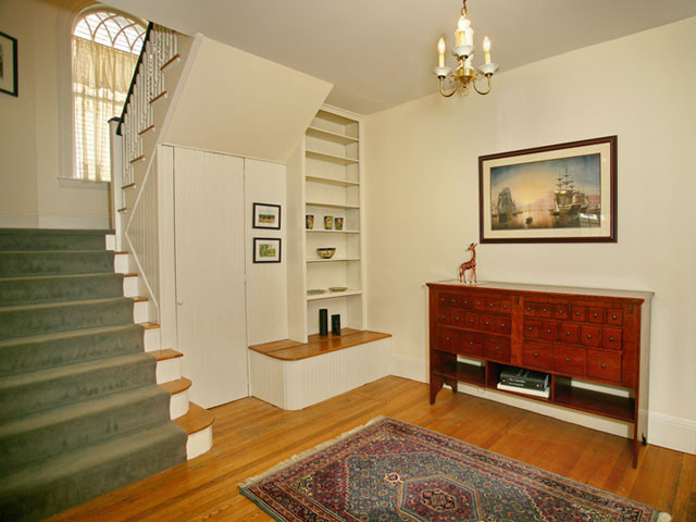 Photo of a traditional entryway in Boston with white walls and light hardwood floors.