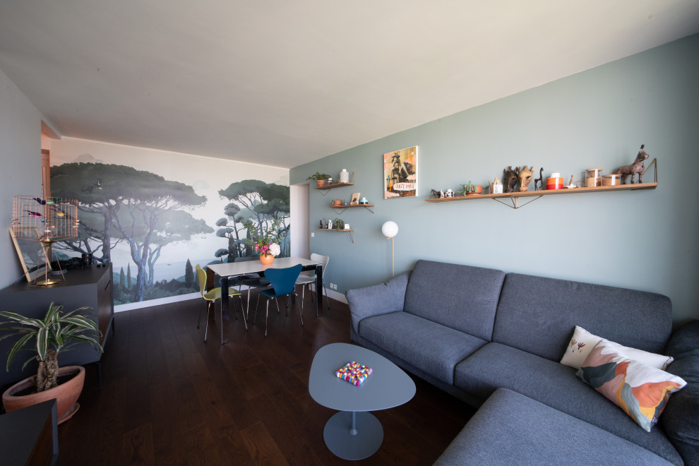 Ejemplo de sala de estar abierta contemporánea de tamaño medio sin chimenea con paredes verdes, suelo de madera en tonos medios, papel pintado, televisor independiente y suelo marrón