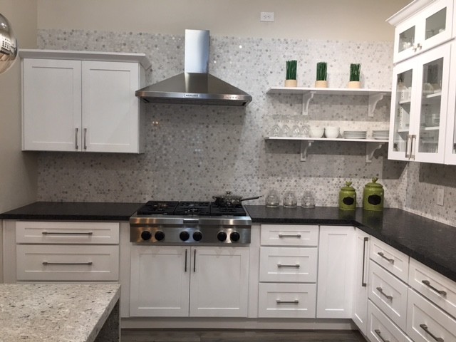 Inspiration for a mid-sized transitional l-shaped dark wood floor and gray floor enclosed kitchen remodel in Orange County with white cabinets, gray backsplash, mosaic tile backsplash, stainless steel appliances, shaker cabinets, granite countertops and an island