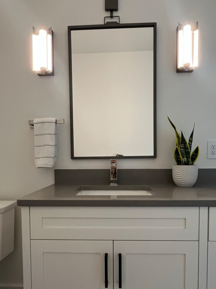 Alcove bathtub - large transitional porcelain tile, white floor and double-sink alcove bathtub idea with raised-panel cabinets, dark wood cabinets, a two-piece toilet, white walls, an undermount sink, quartz countertops, white countertops and a built-in vanity
