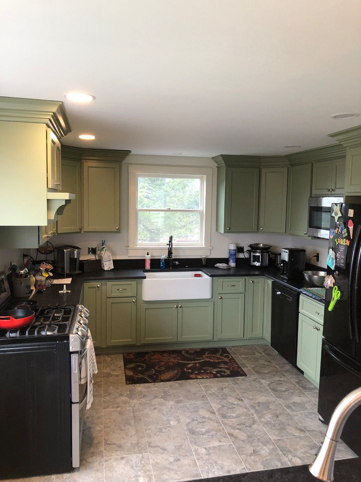 Design ideas for a small country u-shaped separate kitchen in Burlington with a farmhouse sink, recessed-panel cabinets, green cabinets, black appliances, no island, grey floor and black benchtop.