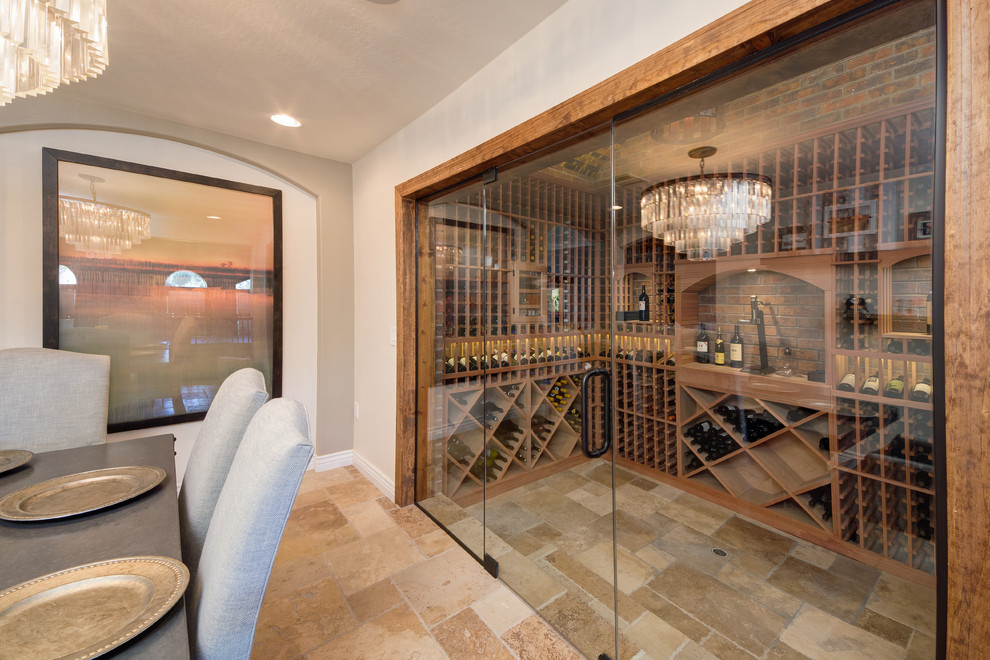 Design ideas for a large traditional wine cellar in Phoenix with travertine floors and diamond bins.