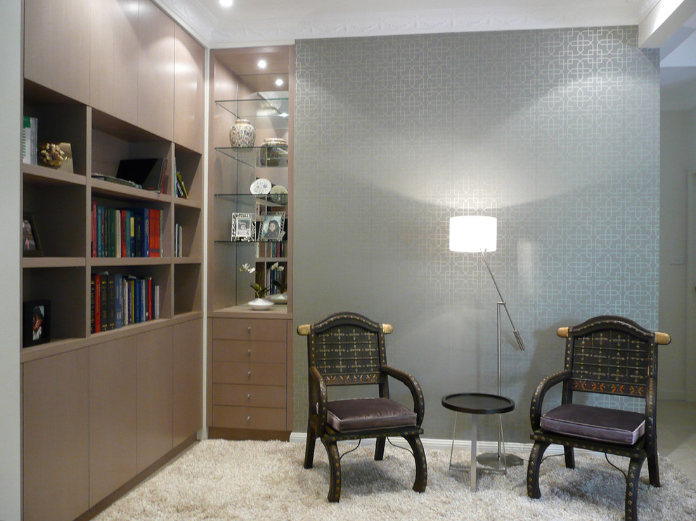 Mid-sized contemporary family room in Sydney with a library, white walls, carpet and beige floor.