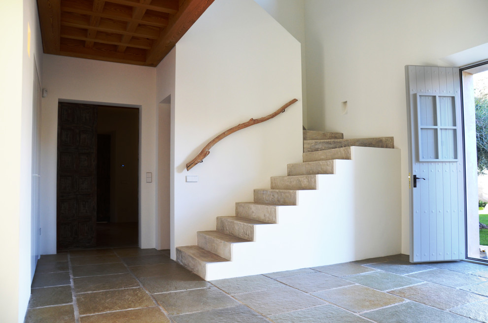 Inspiration for a mid-sized country concrete u-shaped staircase in Other with concrete risers.