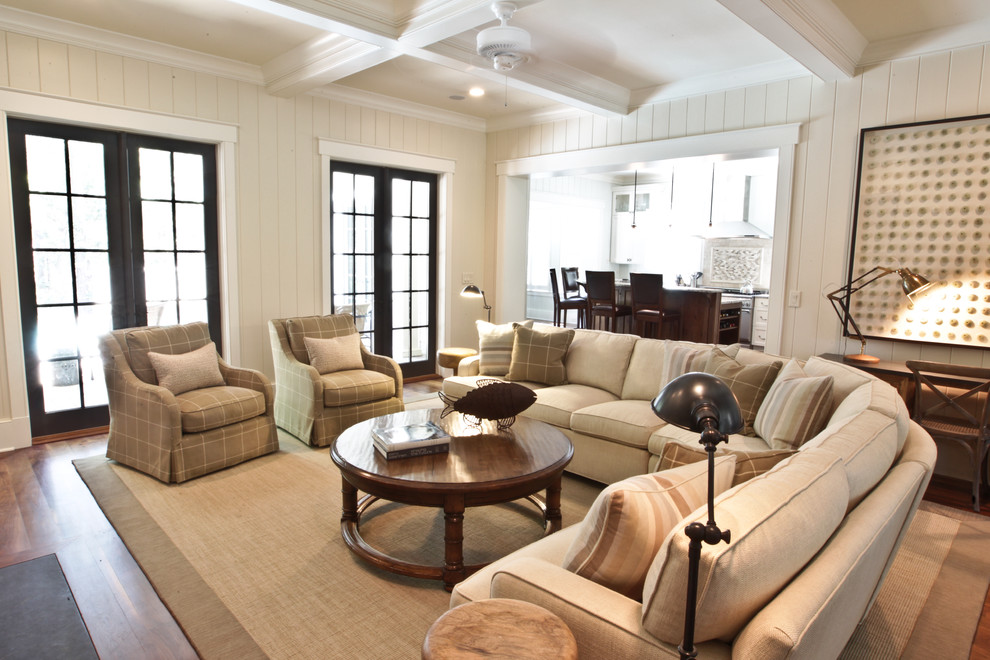 Expansive beach style living room in Charleston with white walls.