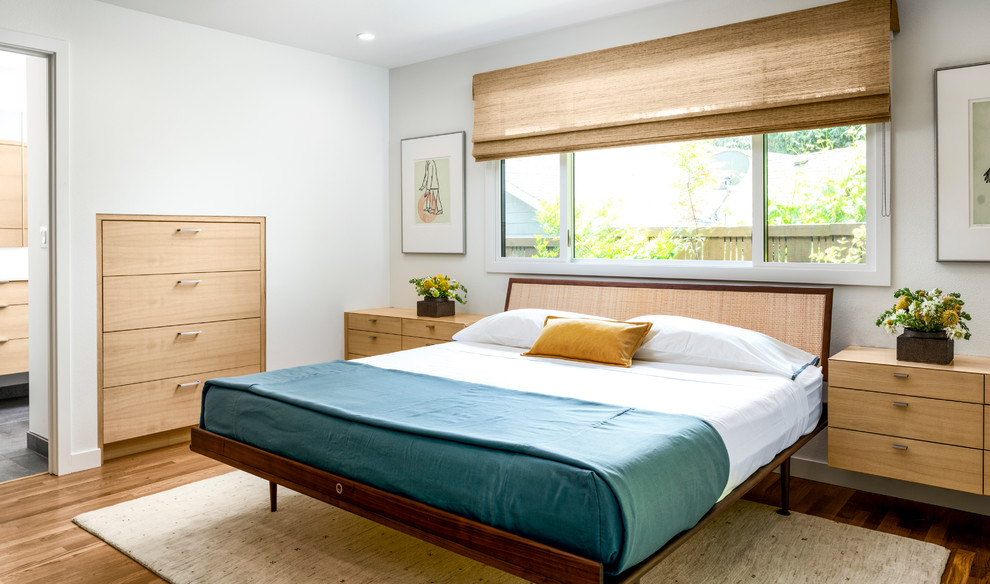 Inspiration for a midcentury bedroom in Portland with white walls and light hardwood floors.