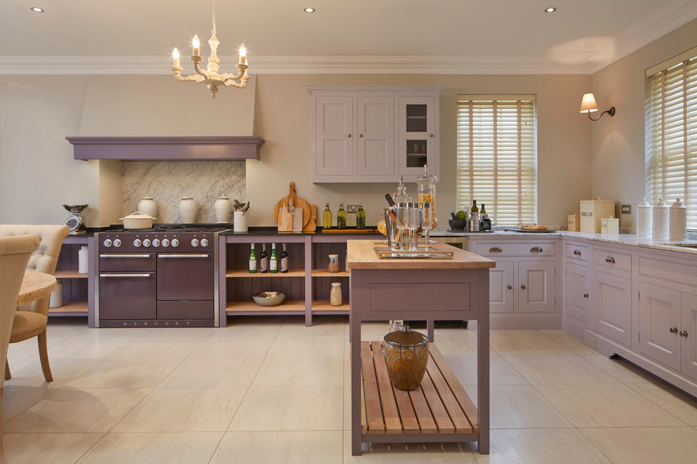 Photo of a large traditional l-shaped eat-in kitchen in Wiltshire with an undermount sink, raised-panel cabinets, marble benchtops, coloured appliances, porcelain floors and with island.