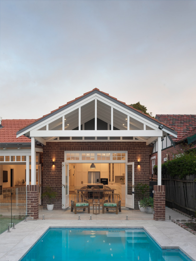 Example of a transitional home design design in Sydney