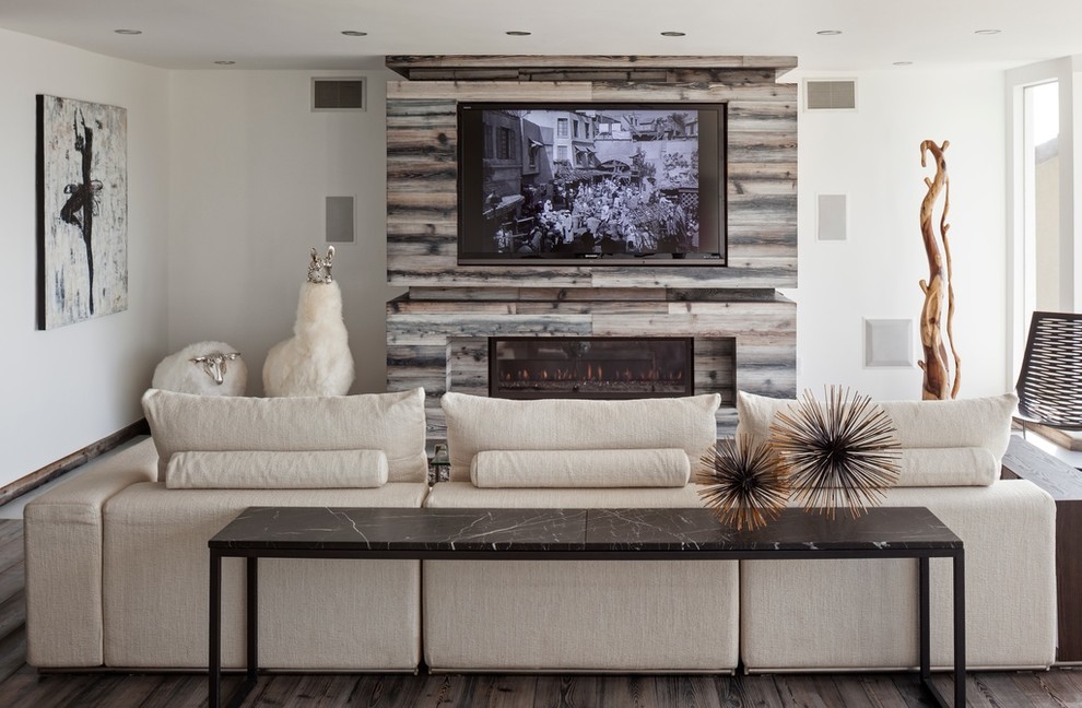 Inspiration for a contemporary living room in Los Angeles with white walls, dark hardwood floors, a ribbon fireplace and a wood fireplace surround.