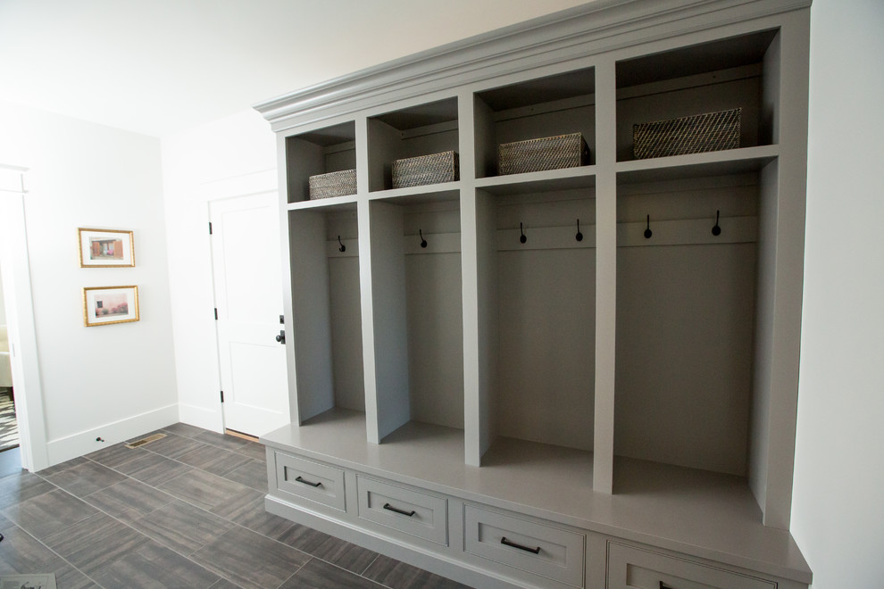 Inspiration for a large transitional mudroom in Other with white walls, porcelain floors and grey floor.
