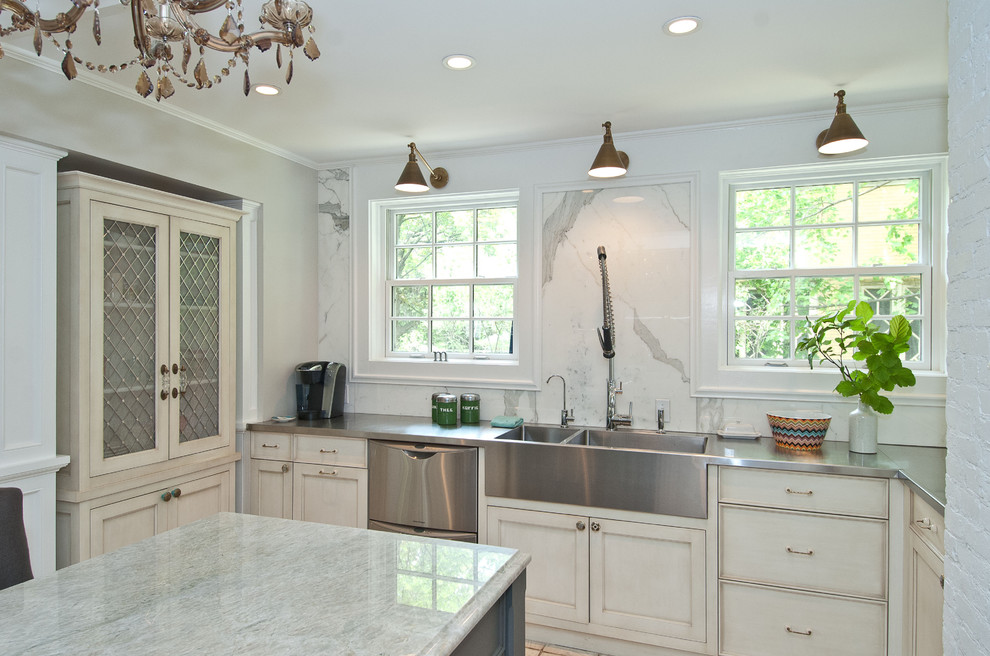 Photo of a traditional kitchen in Chicago with stainless steel benchtops, an integrated sink, white cabinets, white splashback, shaker cabinets, stainless steel appliances and marble splashback.