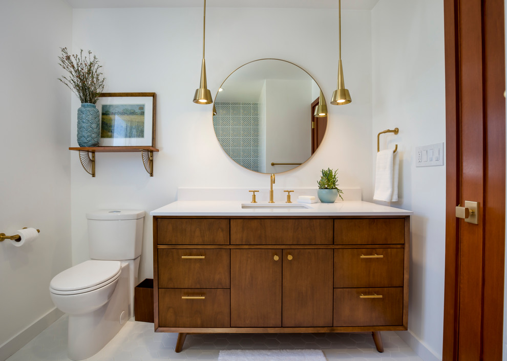 Design ideas for a mid-sized midcentury bathroom in Los Angeles with medium wood cabinets, white walls, engineered quartz benchtops, a two-piece toilet, an undermount sink, white floor, a shower/bathtub combo, white tile, ceramic tile, porcelain floors, a hinged shower door, a drop-in tub and flat-panel cabinets.