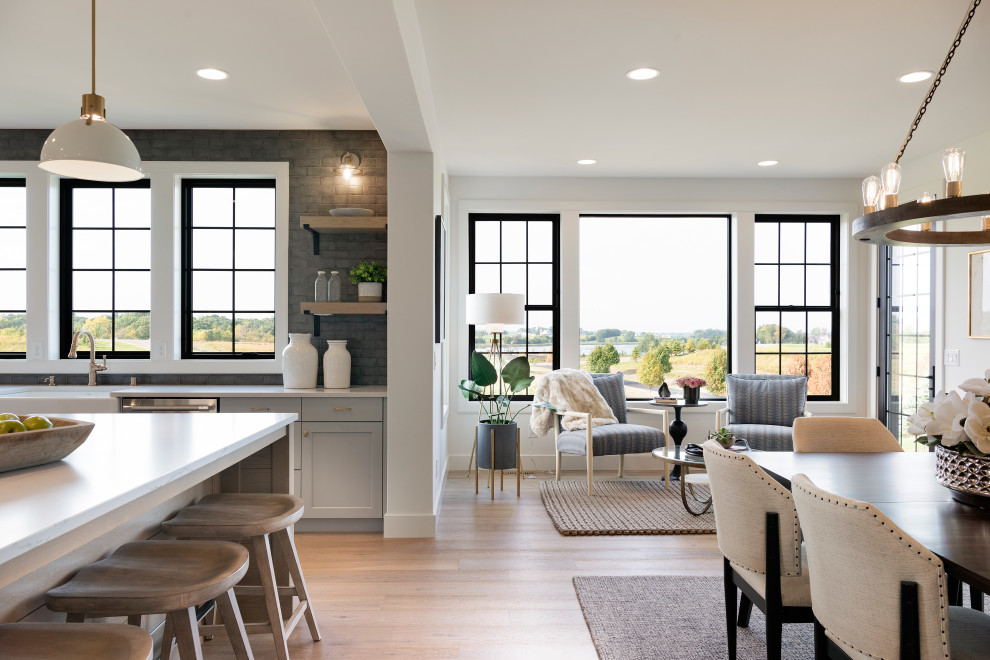 Design ideas for an expansive transitional u-shaped kitchen in Minneapolis with a farmhouse sink, shaker cabinets, grey cabinets, grey splashback, stainless steel appliances, with island and white benchtop.