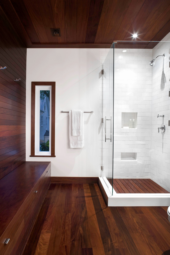 Contemporary bathroom in Austin with a corner shower, white tile, subway tile, white walls and dark hardwood floors.