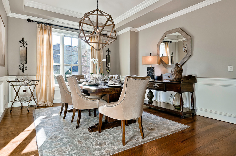 Design ideas for a transitional separate dining room in Other with dark hardwood floors and beige walls.