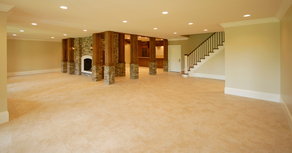 Large mountain style walk-out carpeted and beige floor basement photo in Birmingham with beige walls, a two-sided fireplace and a stone fireplace
