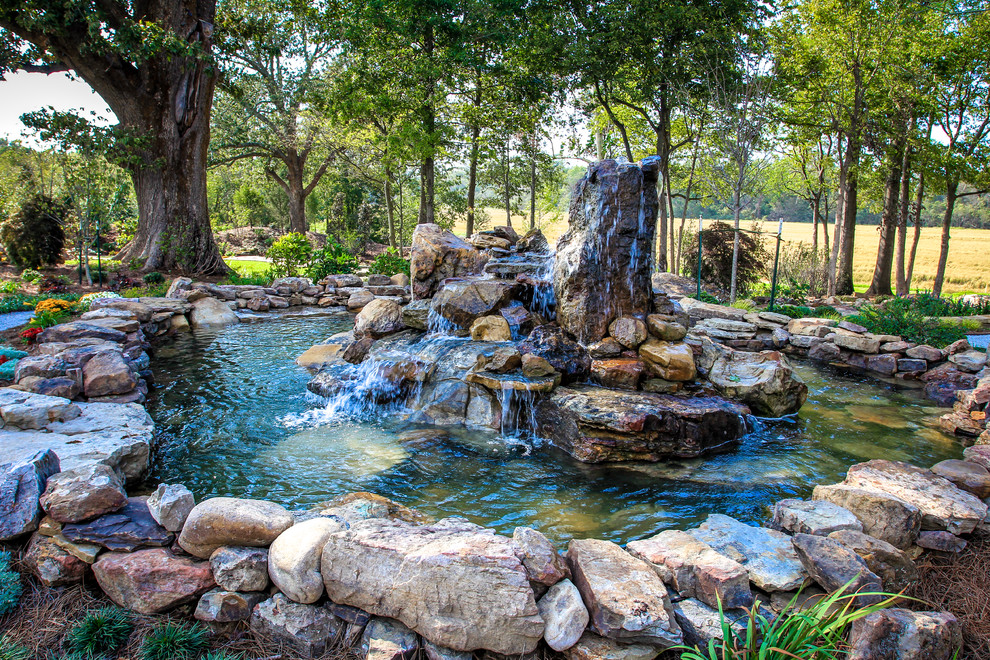 This is an example of a traditional garden in Little Rock with a water feature.