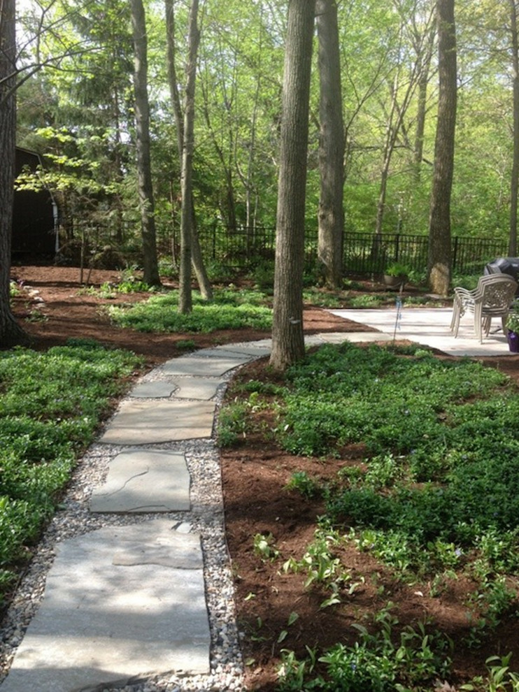 This is an example of a large shade backyard stone garden path.