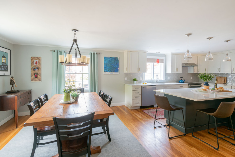 Eat-in kitchen - large transitional l-shaped light wood floor and brown floor eat-in kitchen idea in Boston with an undermount sink, shaker cabinets, white cabinets, quartz countertops, gray backsplash, ceramic backsplash, stainless steel appliances, an island and white countertops