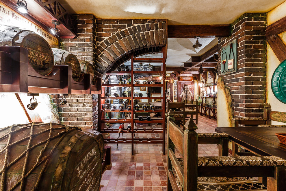 This is an example of an eclectic wine cellar in Other with storage racks and brown floor.