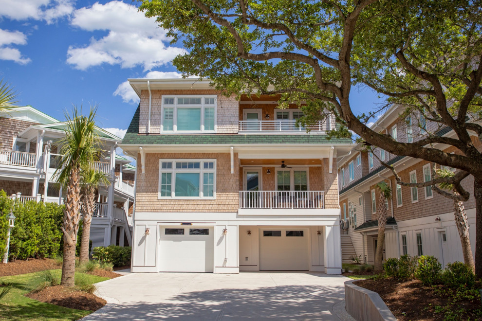 Example of a huge beach style yellow two-story wood and shingle apartment exterior design in Wilmington with a butterfly roof, a shingle roof and a gray roof