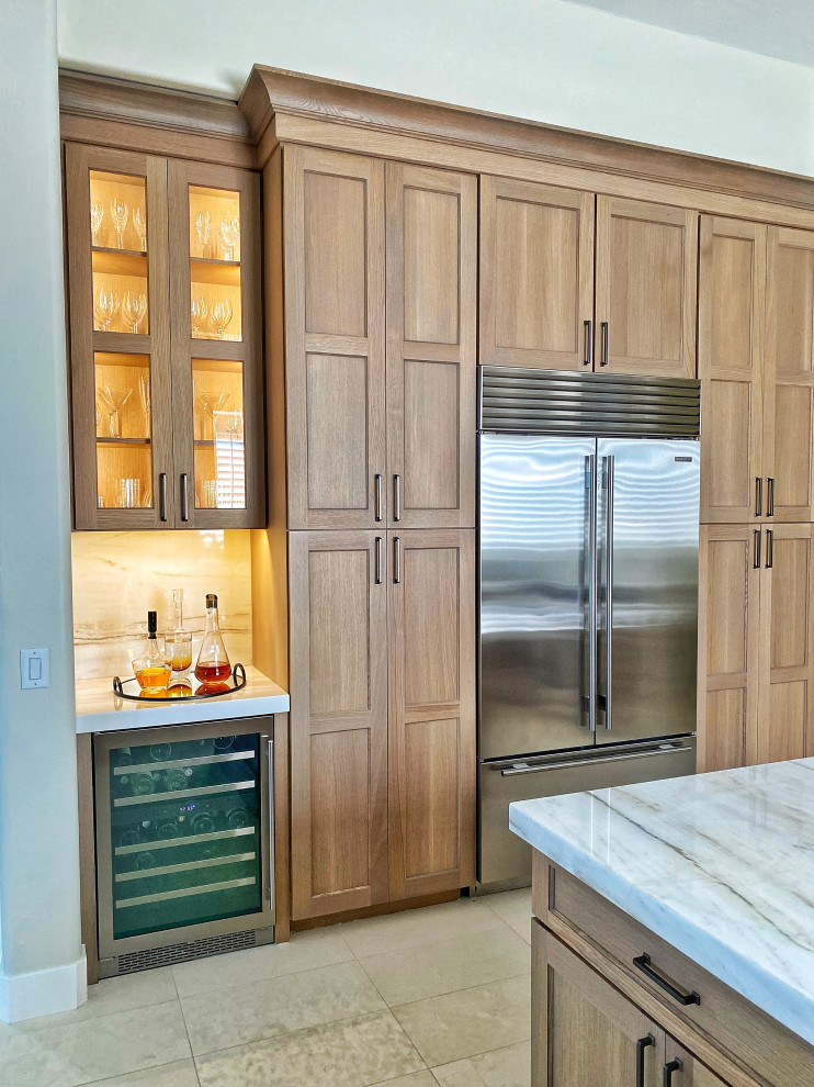 Large country u-shaped separate kitchen in Phoenix with an undermount sink, shaker cabinets, medium wood cabinets, quartzite benchtops, beige splashback, stainless steel appliances, ceramic floors, with island, beige floor and beige benchtop.