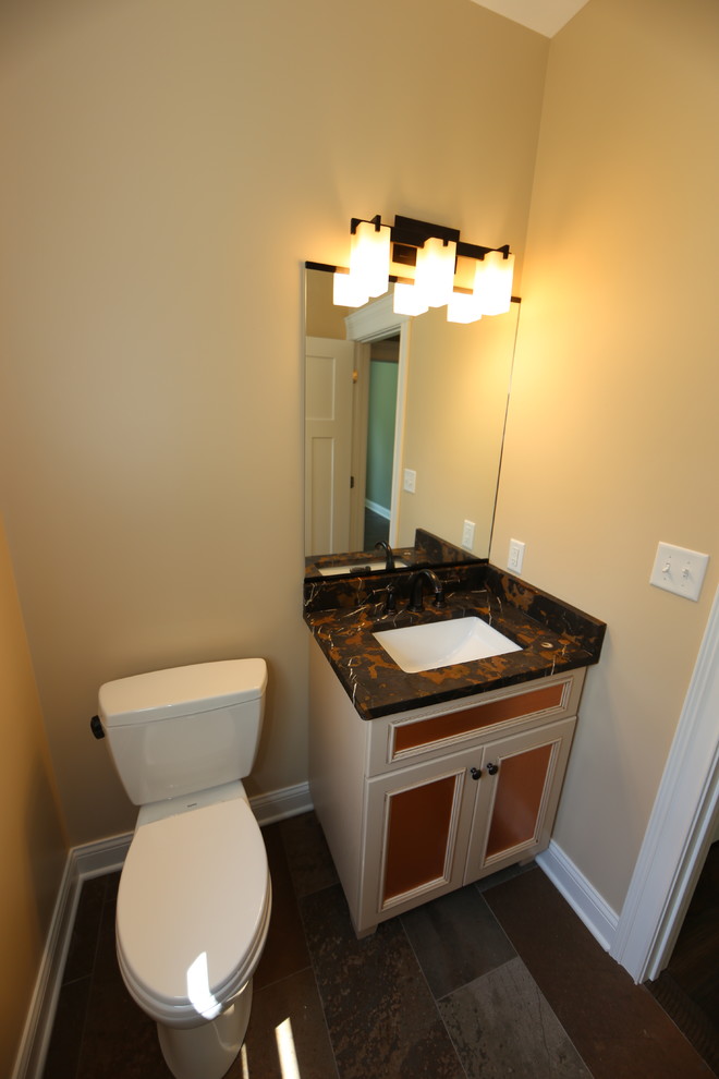 Design ideas for a small arts and crafts powder room in Chicago with flat-panel cabinets, beige cabinets, brown walls, ceramic floors, granite benchtops and multi-coloured floor.