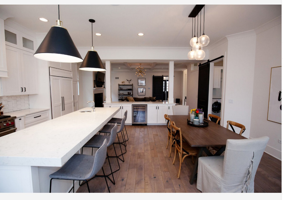 Inspiration for a mid-sized transitional kitchen/dining combo in Chicago with white walls, medium hardwood floors, no fireplace and brown floor.