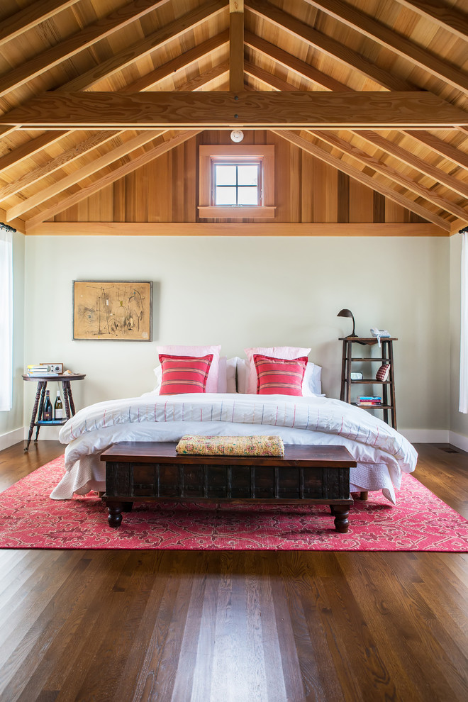 Large country master bedroom in Boston with grey walls, dark hardwood floors and brown floor.