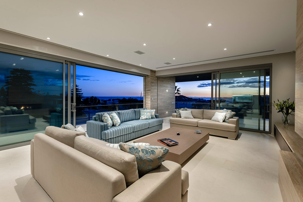 This is an example of a large contemporary open concept living room in Perth with beige walls and travertine floors.