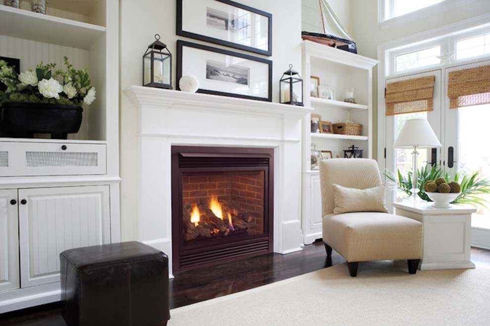 Photo of a mid-sized transitional enclosed living room in Kansas City with a standard fireplace, white walls, dark hardwood floors and a plaster fireplace surround.