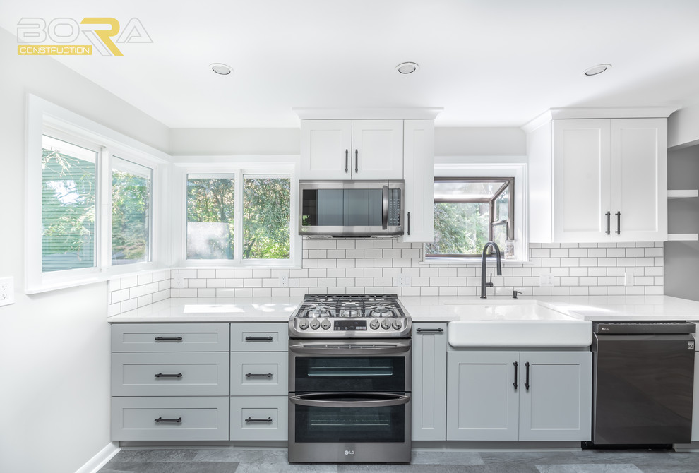 Mid-sized transitional galley eat-in kitchen in Seattle with a farmhouse sink, shaker cabinets, yellow cabinets, quartz benchtops, white splashback, ceramic splashback, stainless steel appliances, vinyl floors, no island and grey floor.