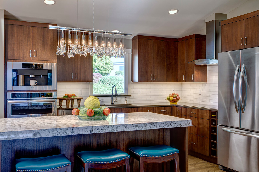 Small transitional l-shaped medium tone wood floor open concept kitchen photo in Seattle with a single-bowl sink, flat-panel cabinets, dark wood cabinets, quartz countertops, white backsplash, ceramic backsplash, stainless steel appliances and an island