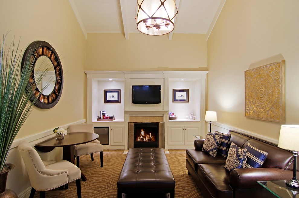 Design ideas for a mid-sized traditional formal enclosed living room in San Francisco with beige walls, carpet, a standard fireplace, a tile fireplace surround and a wall-mounted tv.