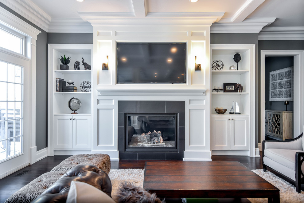 Inspiration for a large transitional formal open concept living room in Edmonton with grey walls, vinyl floors, a standard fireplace, a plaster fireplace surround, a built-in media wall and brown floor.