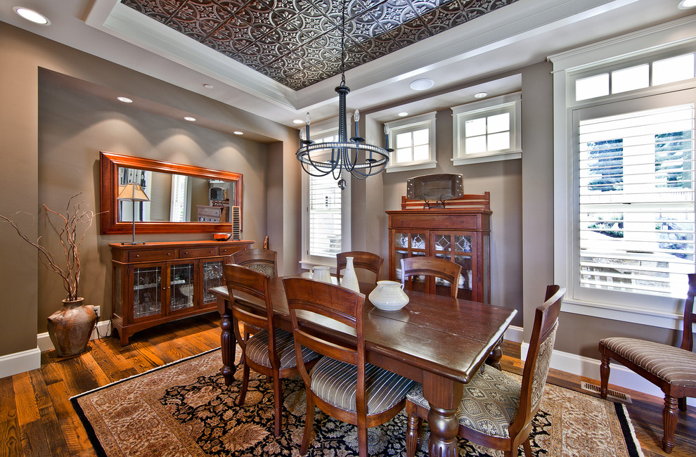 Design ideas for a traditional dining room in Seattle with brown walls and dark hardwood floors.