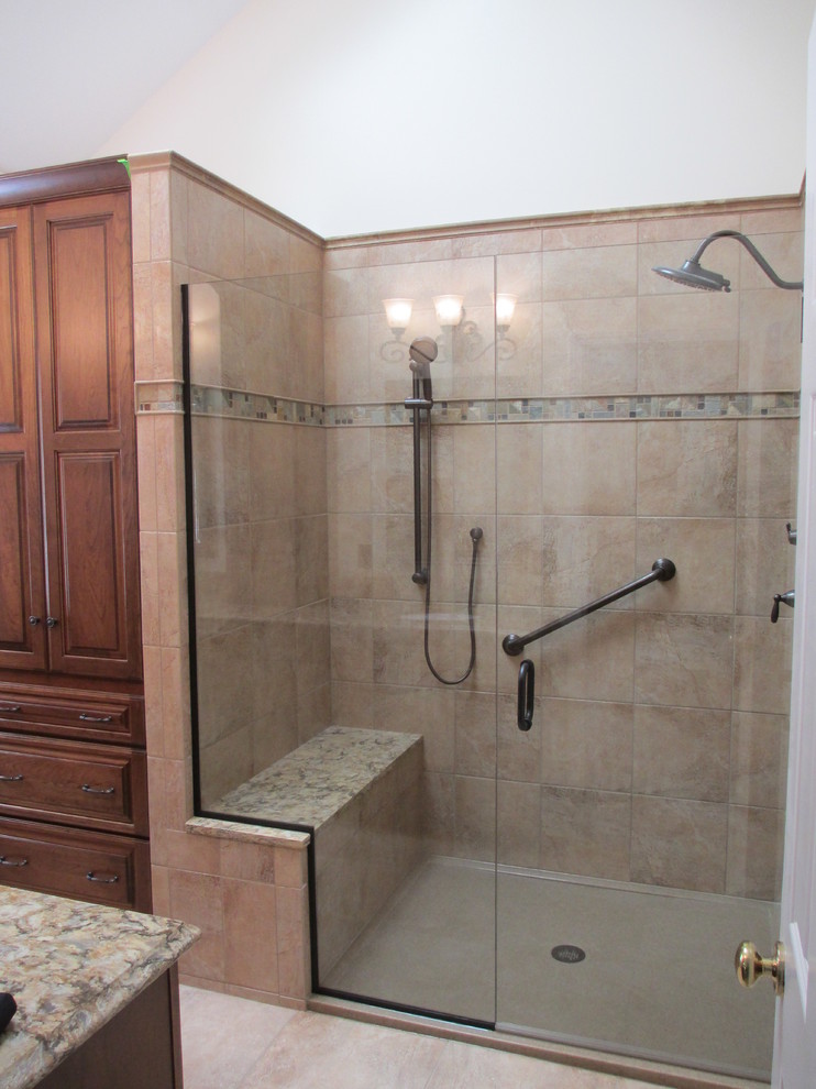 Inspiration for a traditional bathroom in St Louis with granite benchtops, a corner shower and beige tile.